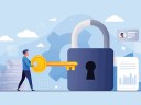 A SMB owner with a key unlocks a padlock, representing data protection, privacy, and secure access management solutions.
