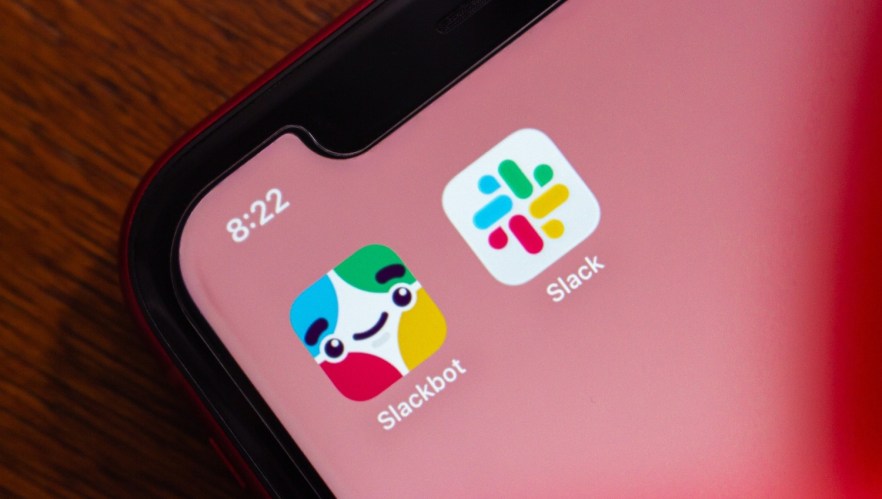 A capture of a smart phone showcasing the Slackbot and Slack apps on a red screen background.