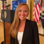 Caucasian, blonde young female in a professional setting.