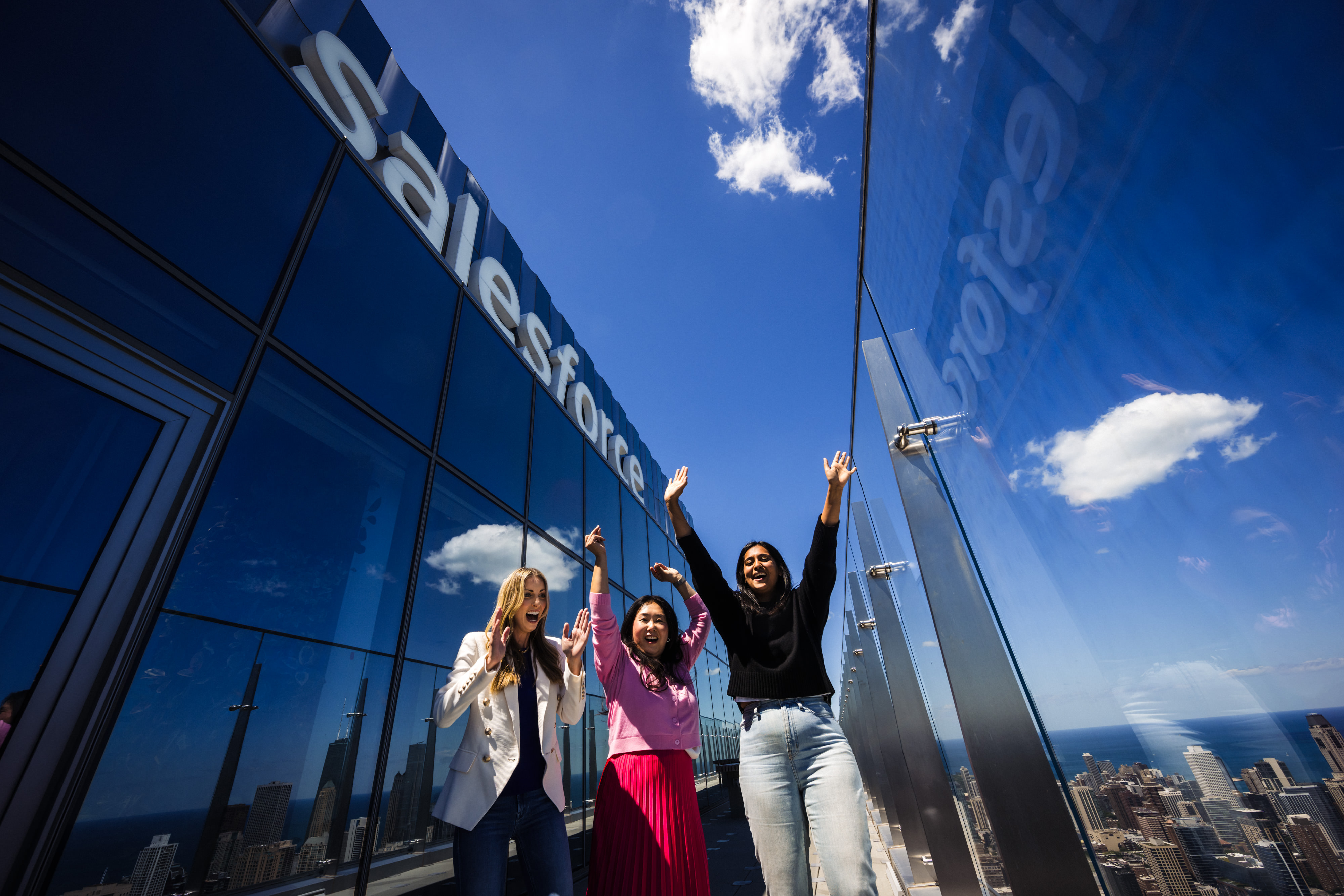 group of employees cheer outside of a salesforce office