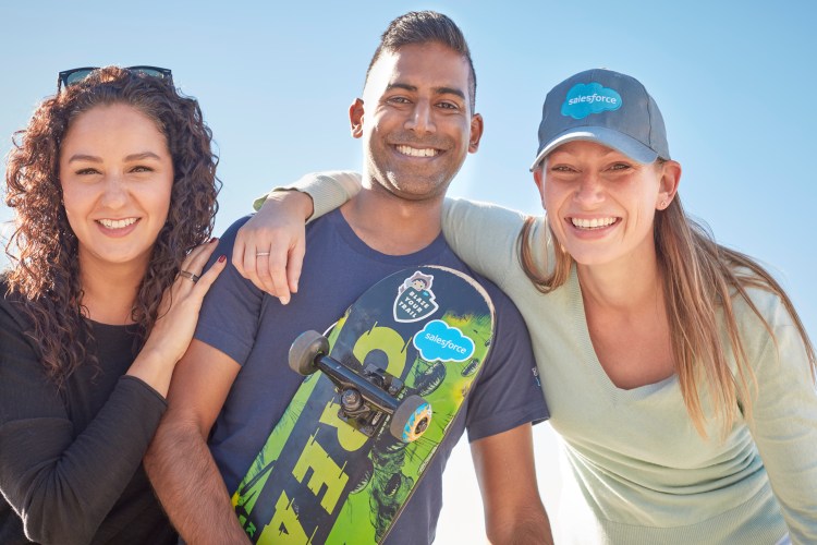 group of three salesforce employees smiling outside