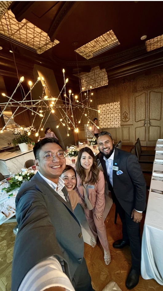 group of employees take a selfie at a dinner