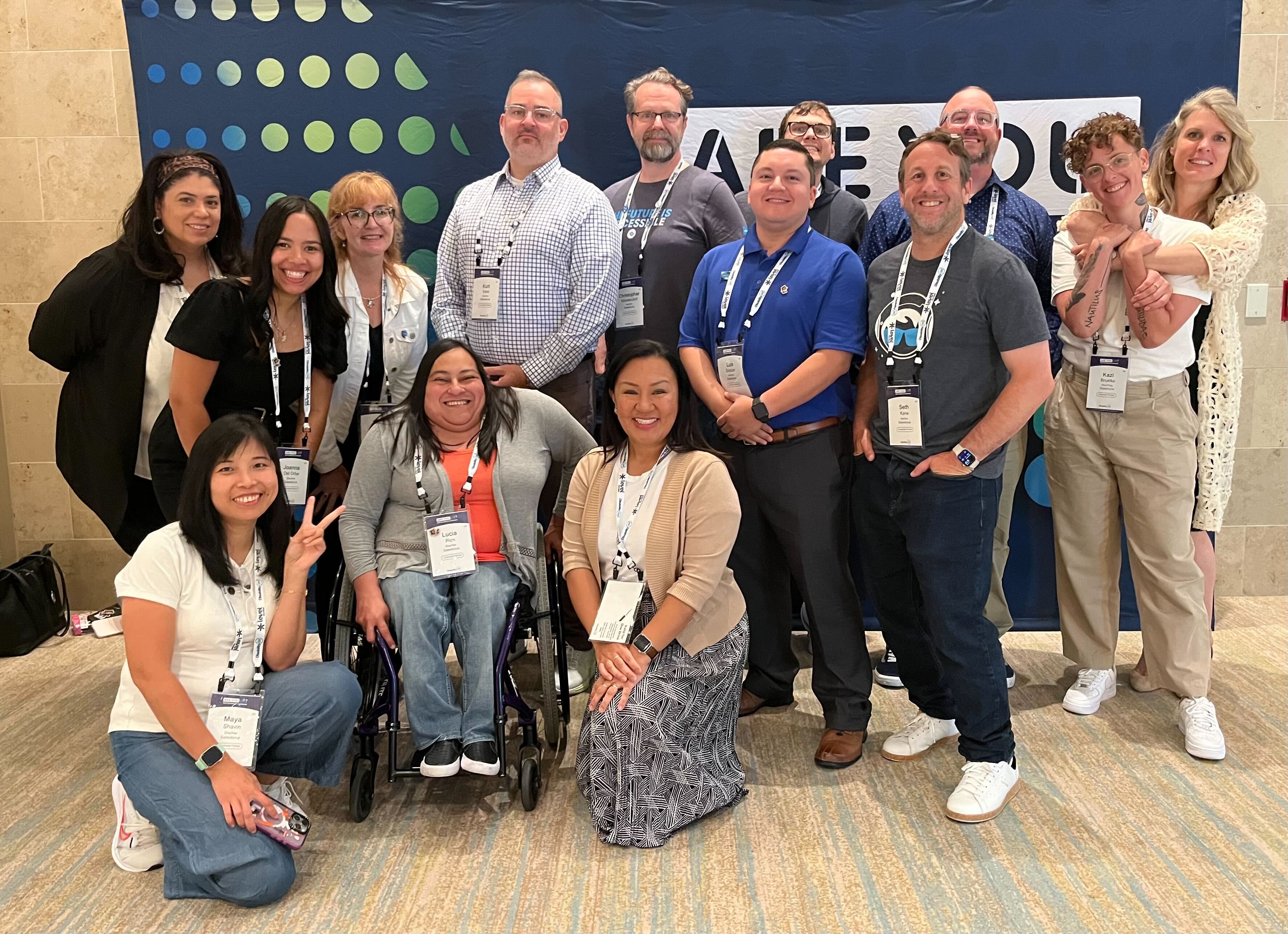 Salesforce apprentices and team, including Luis Salazar, smiling together at an accessibility conference.