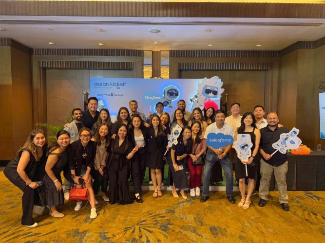 group of employees pose at a Salesforce event