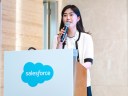woman stands at podium to give speech at an event