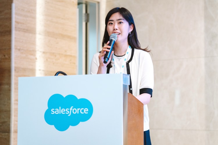 woman stands at podium to give speech at an event