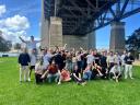 A team of people together on a grassy field.