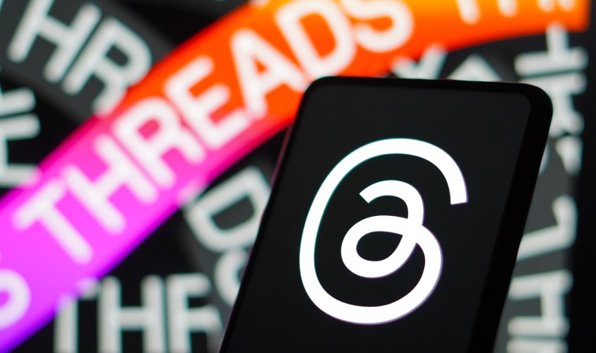 Threads icon and and decal on a mobile phone.