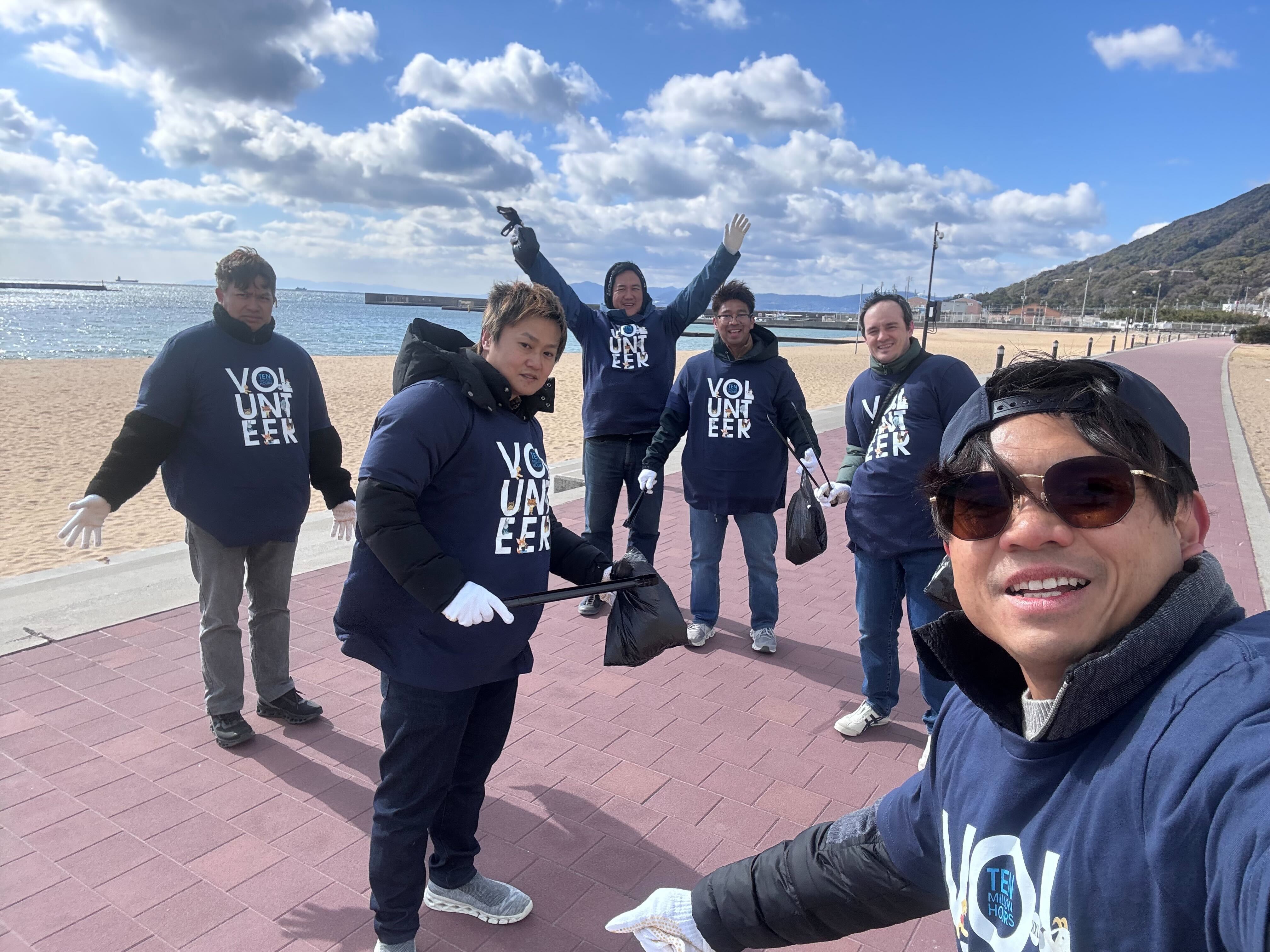 Salesforce team members cleaning up trash along the beach as part of VTO