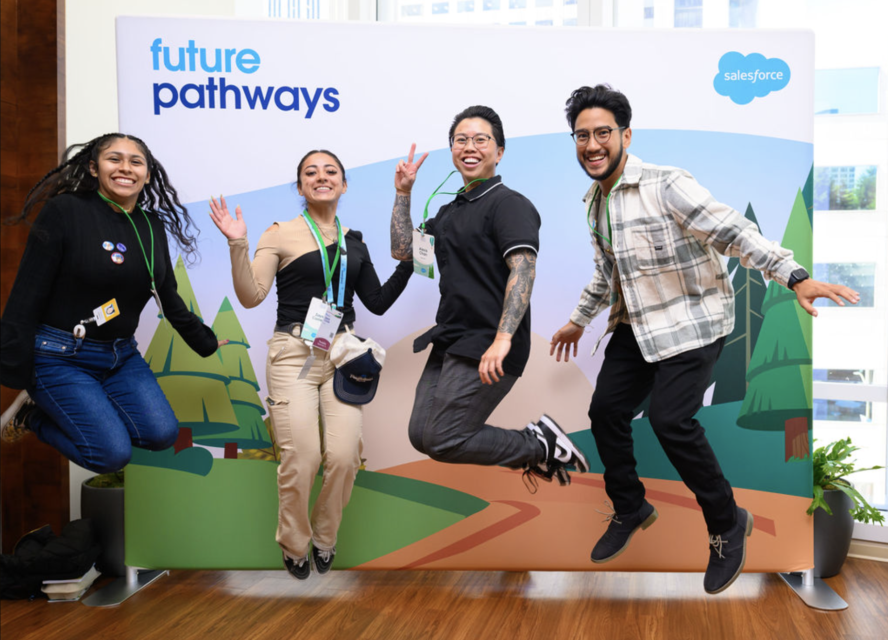 A group of 4 Future Pathways hires jump and pose together in front of a program backdrop.