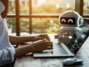Person on laptop while AI agent is on screen.