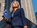 Businesswoman walking with phone supported by AI agent in a city