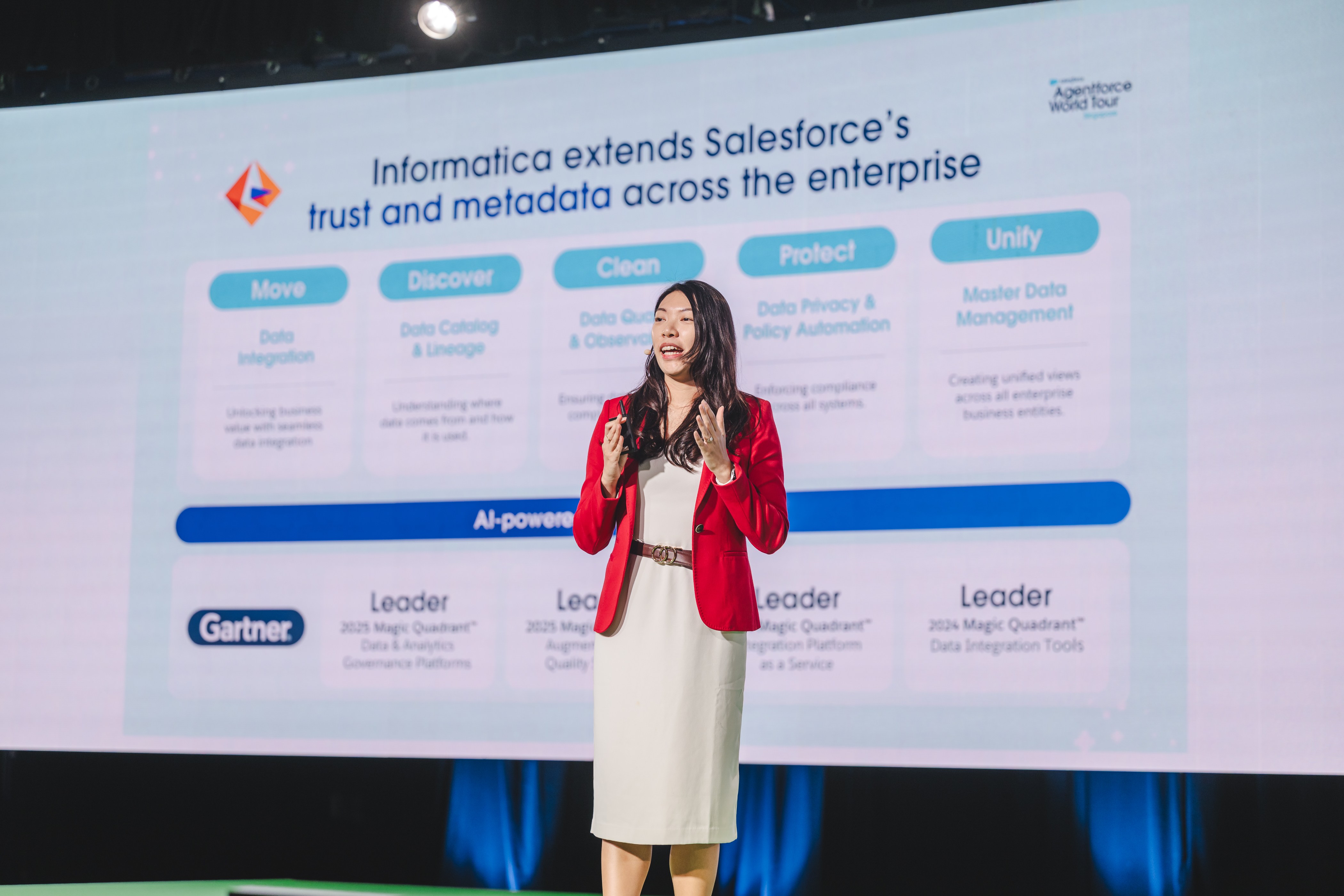 A woman on stage giving a presentation