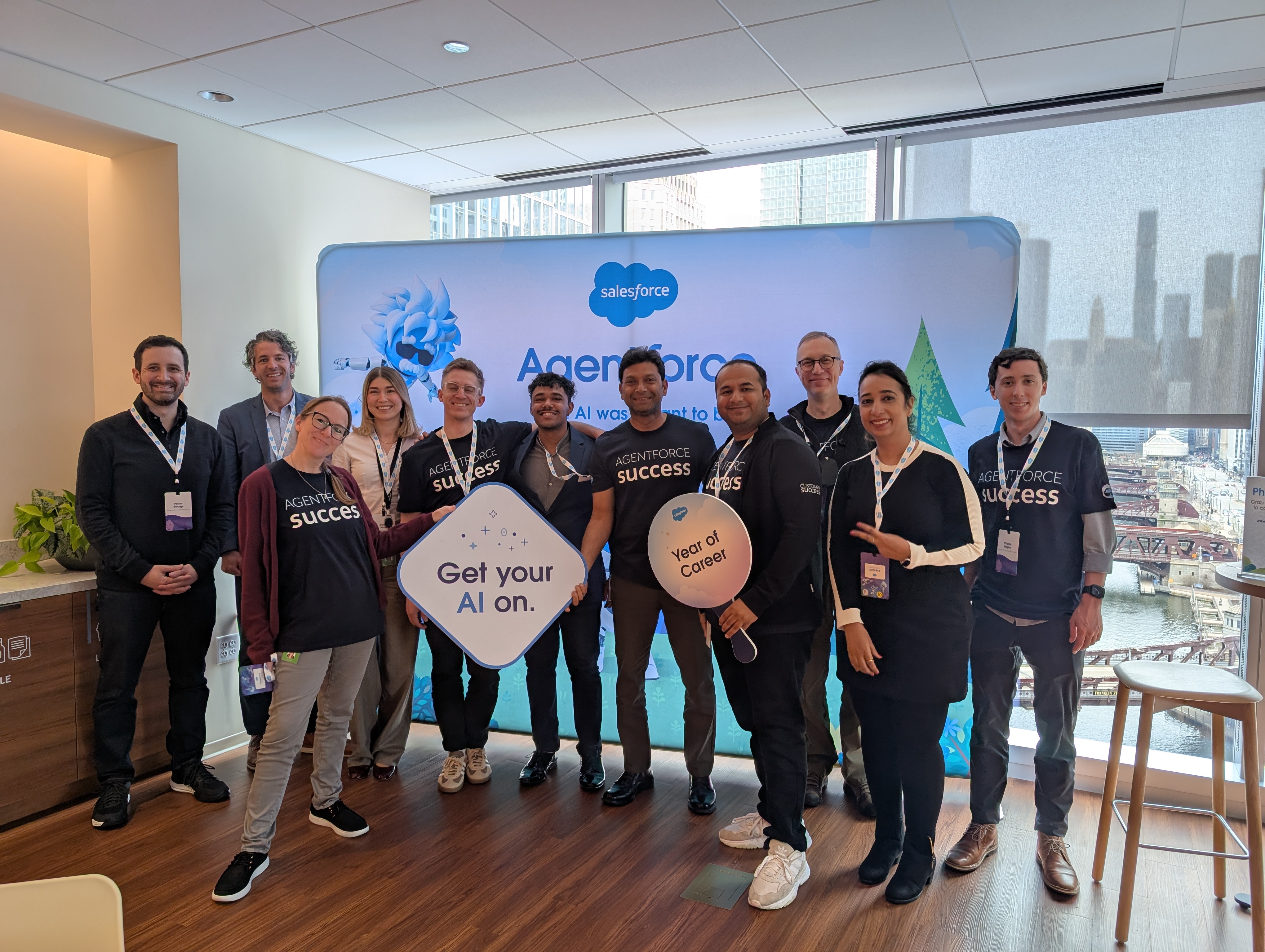 A group of people together holding Salesforce signs