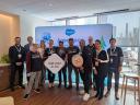 A group of people together holding Salesforce signs