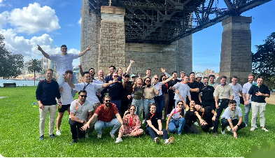 A group of people together on the grass