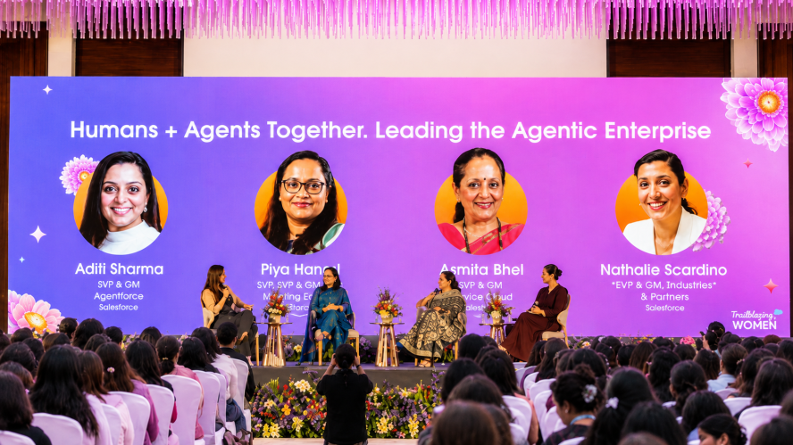 A group of women on stage speaking at the TBW India Summit