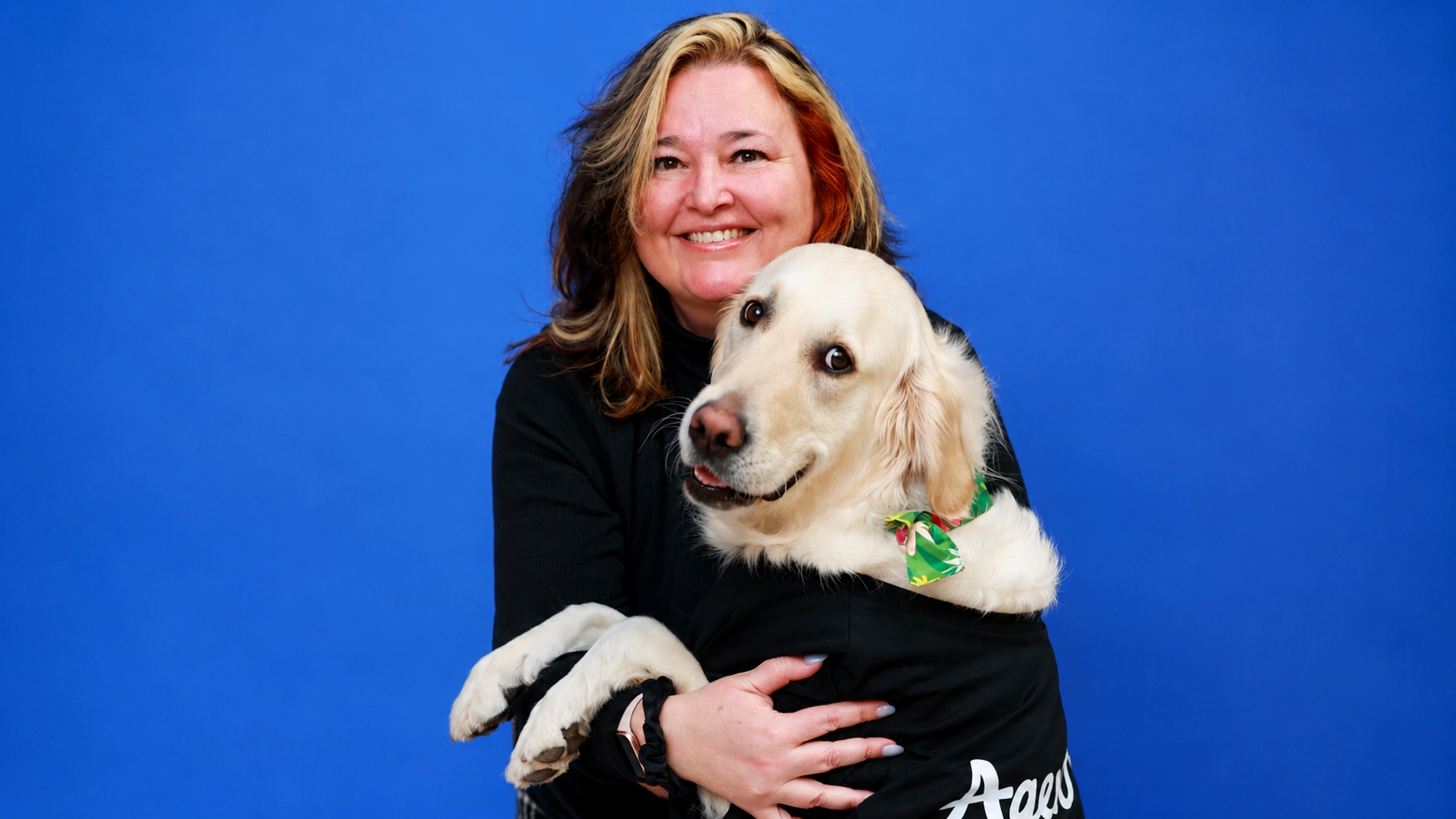 A woman and her dog smiling for camera