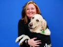 A woman and her dog smiling for camera
