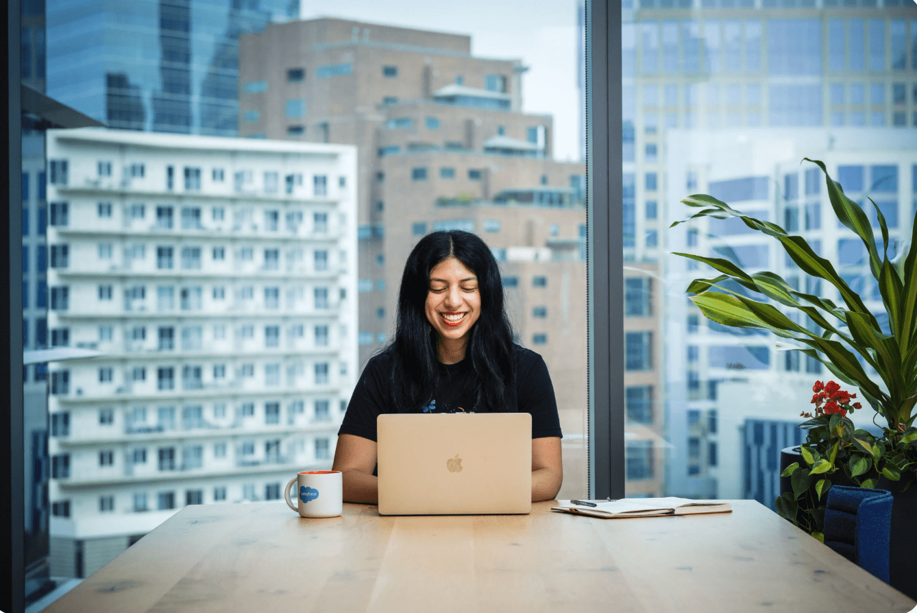 Woman at the computer in front of a large window