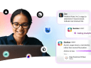 A woman looking at her laptop with Salesforce and Slackbot icons