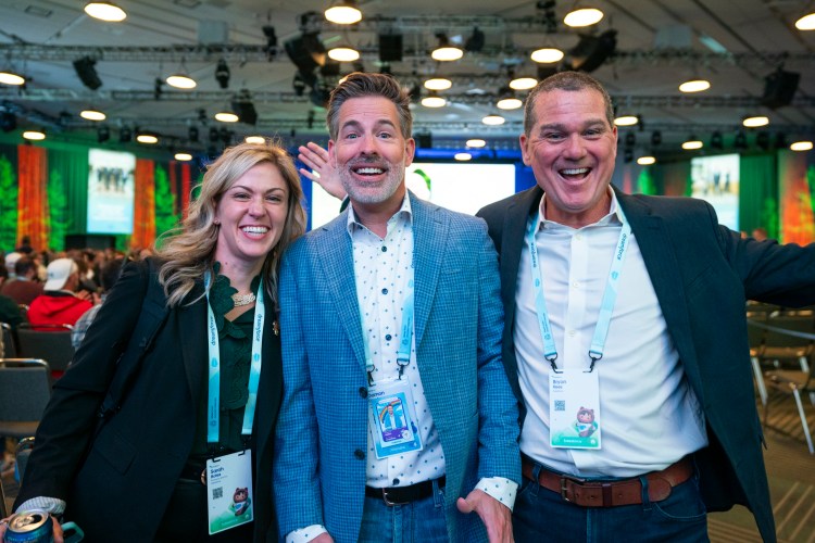 Dreamforce attendees smiling into camera after a session.