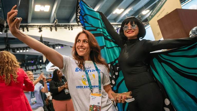 Attendee in a butterfly costume posing for a photo