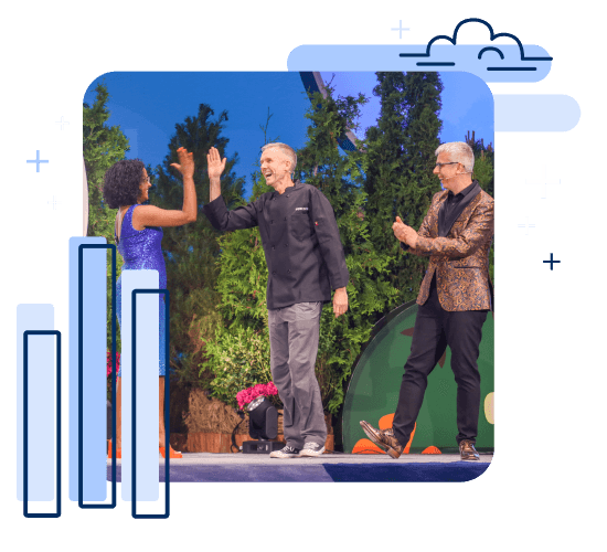 Archana Ganeshalingam high-fives Paul Ross after his 2023 Iron Viz win as Andy Cotgreave looks on.