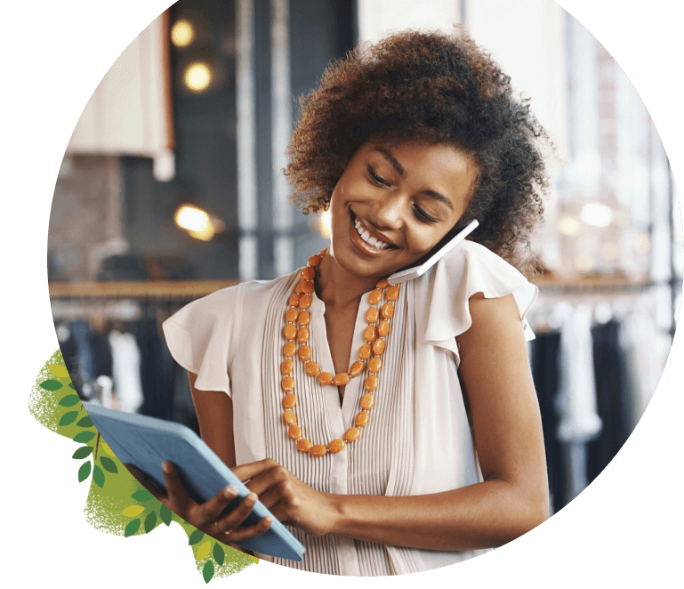 A woman is using Salesforce on her iPad and talking on the phone