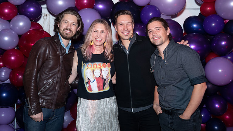 Robin with the band Hanson at the TMP Holiday party.