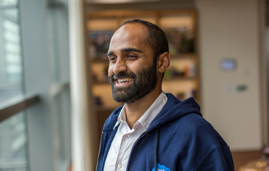 Sarwar Khan from the corporate and legal team smiling and looking out the window