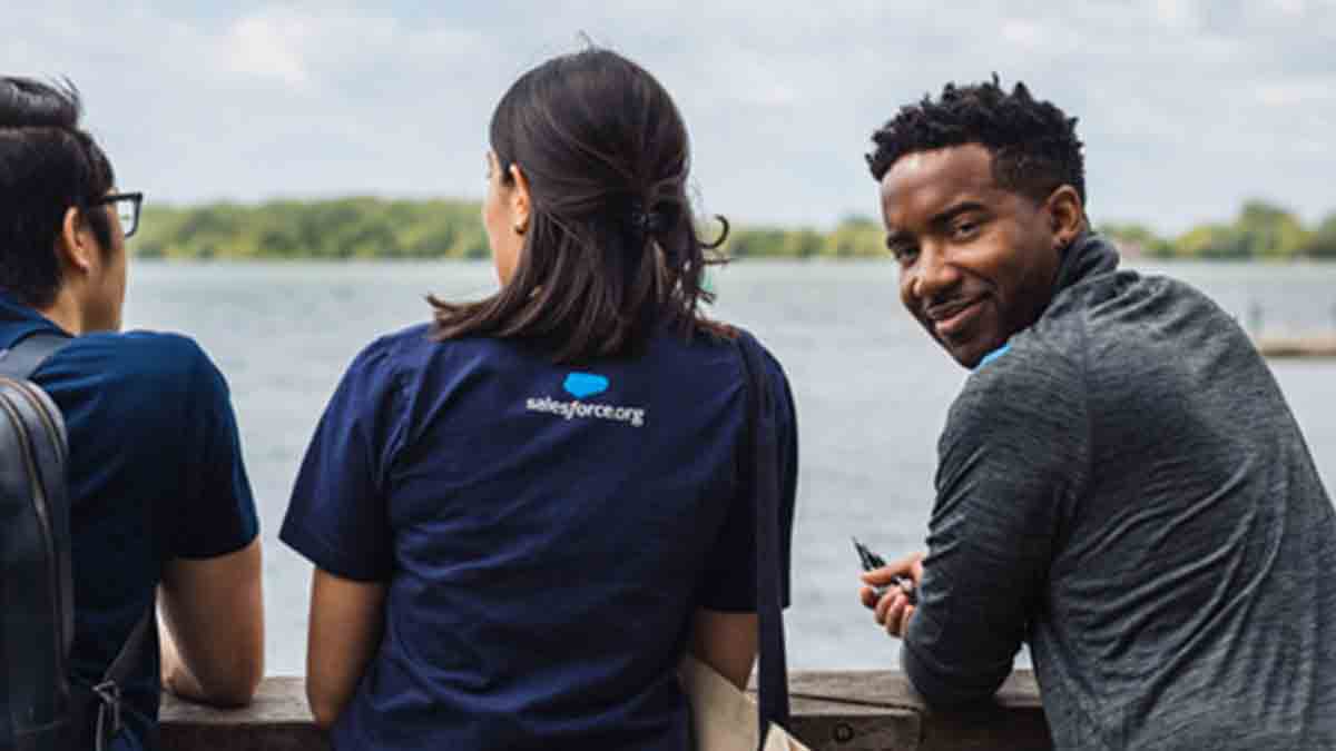 Christopher Roberts from sales team looking over his shoulder and smiling