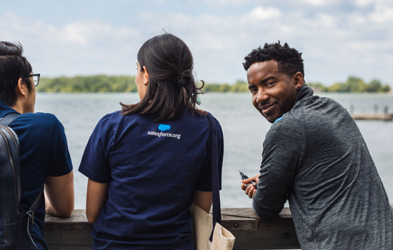 Christopher Roberts from sales team looking over his shoulder and smiling