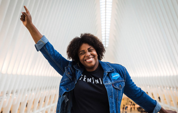 Alexis Douglas from the marketing team celebrating on a bridge
