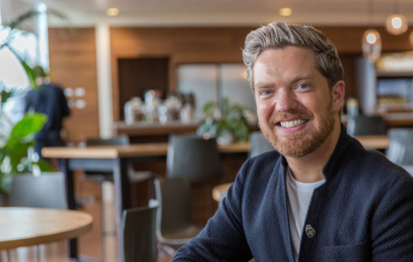 Aaron Lawder from the employee success team smiling in a dublin salesforce kitchen