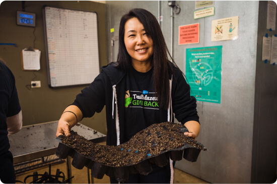 Jin Lee wearing a trailbalzers give back t shirt while on a salesforce volunteer activity 