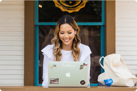 Alice Napper sitting outside working on a laptop
