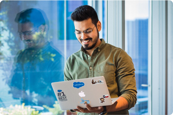 Urvish Shah working on a salesforce laptop