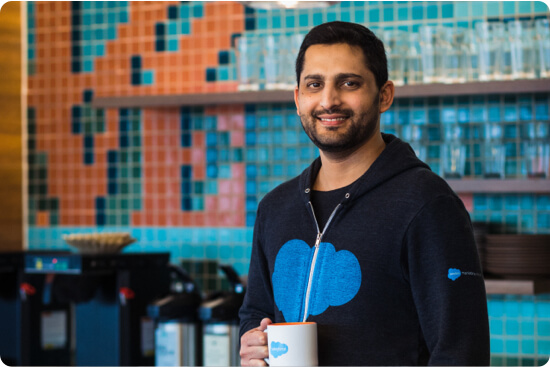 Mohammed Muazzam Fazlullah holding a cup of coffee in a salesforce kitchen