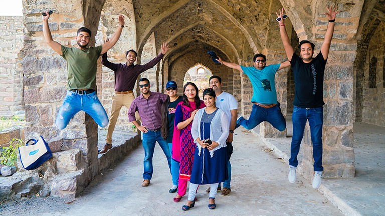 Kiran and colleagues jumping in the air 