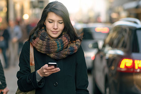 Woman outside looking at mobile phone