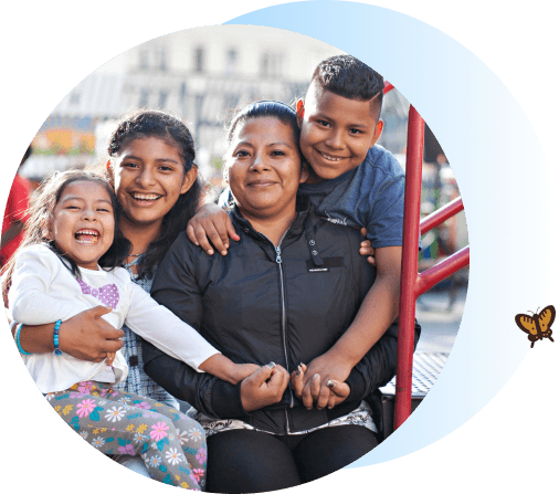 Mom and three kids smiling at the camera