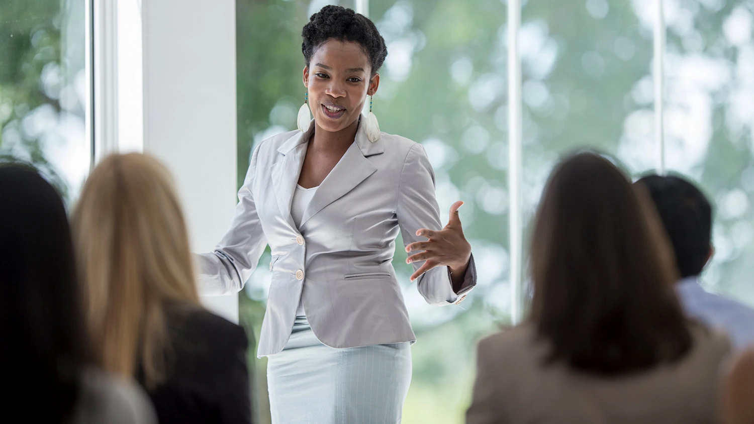 African American woman speaking at a business meeting