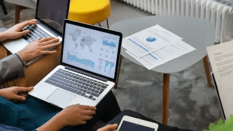 Several laptops open showing CRM dashboards