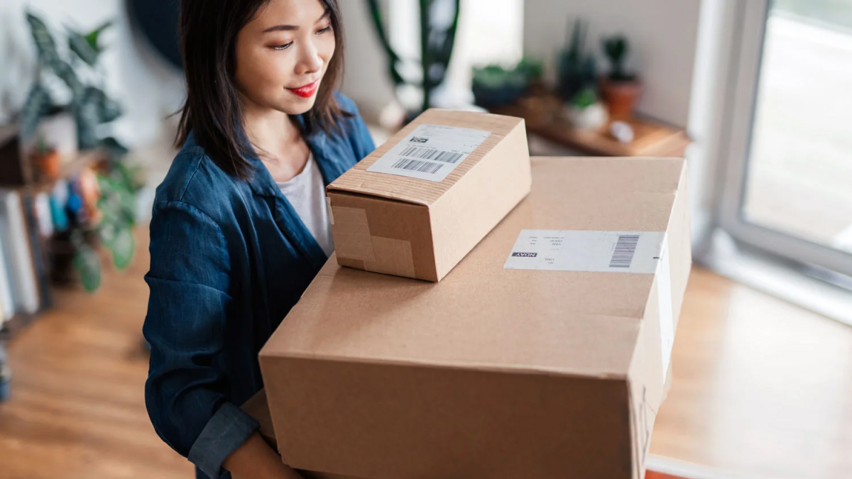 Woman carrying multiple boxes
