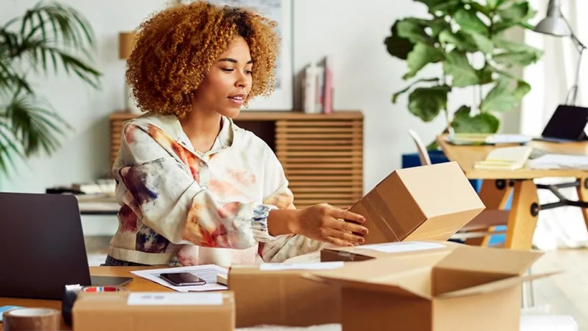 Woman at a desk looking at a package