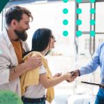 Photo of a man shaking hands with a woman after making an inbound sale.