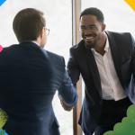 Salesperson shaking hands and smiling while selling to the CFO