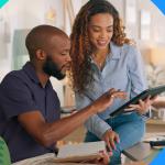 Sales coaching: Two salespeople looking at a tablet