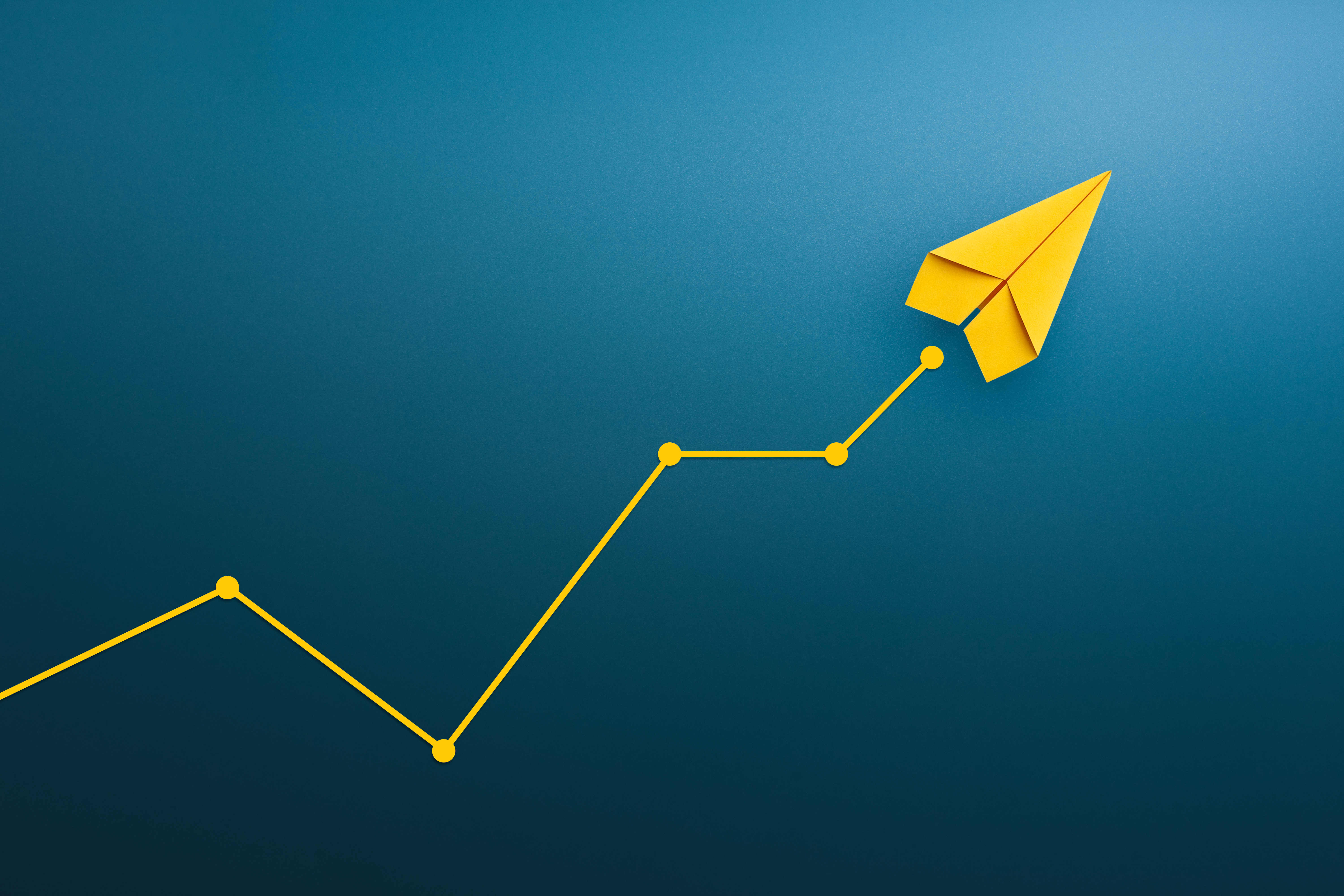 Yellow paper plane, volatility in the business and investment